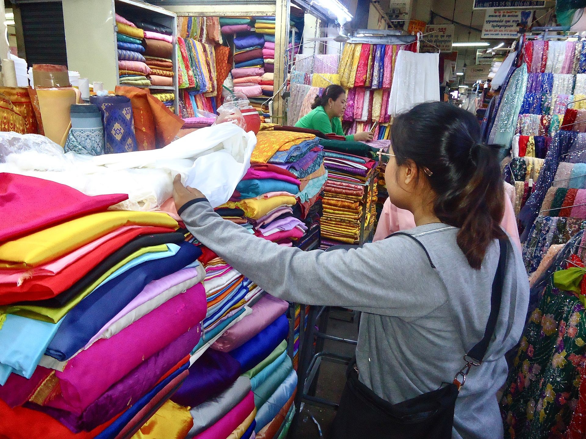 woman looking for sustainable fabrics for fashion manufacturer